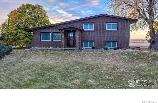 split level home with a lawn