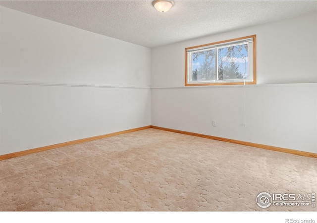 unfurnished room with a textured ceiling and carpet