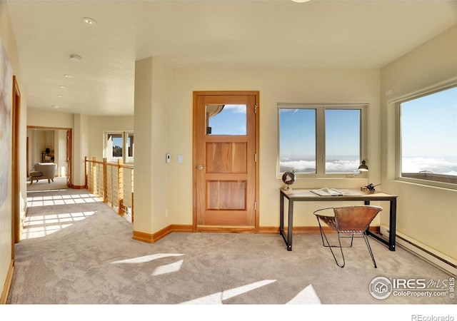 carpeted foyer entrance with a baseboard radiator