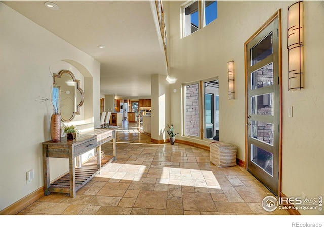 entryway with a towering ceiling