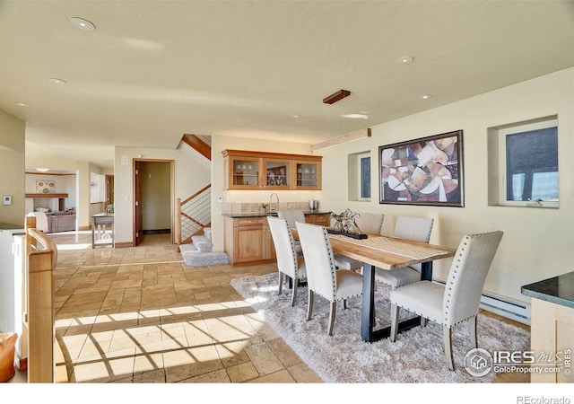 dining area featuring indoor bar and a baseboard radiator