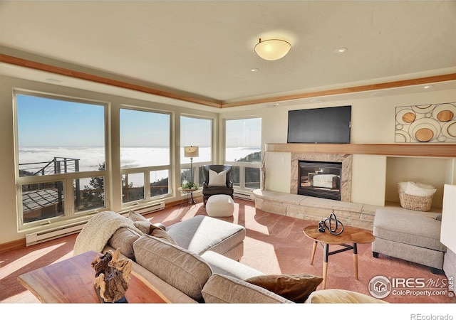 carpeted living room with a high end fireplace, a baseboard heating unit, and a water view