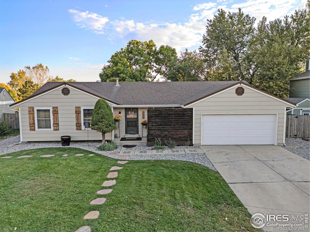 ranch-style home featuring a garage and a front lawn