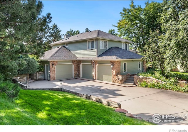 view of front property featuring a front yard and a garage