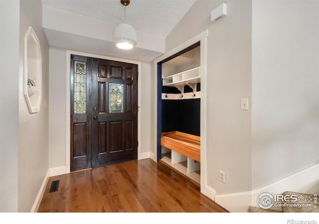 mudroom featuring a textured ceiling and hardwood / wood-style floors