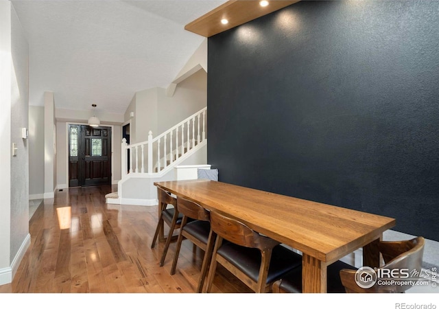 dining area with hardwood / wood-style flooring and lofted ceiling