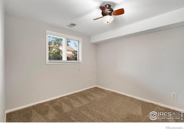 carpeted spare room with ceiling fan