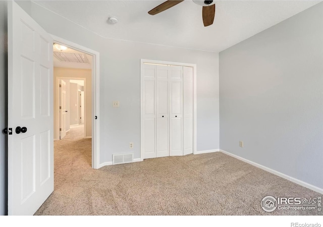 unfurnished bedroom with a closet, ceiling fan, and light carpet