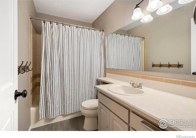 full bathroom with hardwood / wood-style floors, backsplash, toilet, shower / bath combo with shower curtain, and vanity