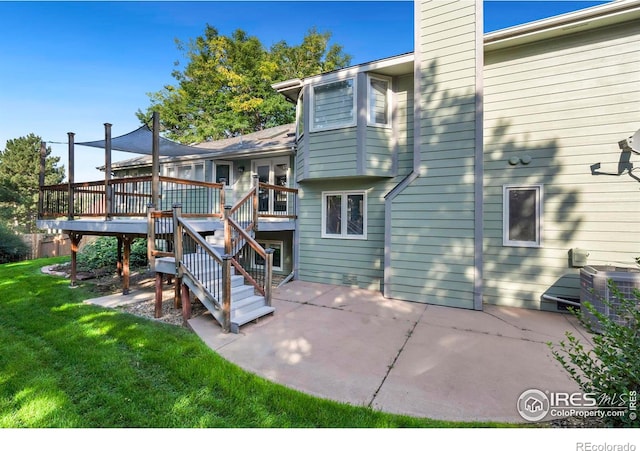 back of property featuring a patio area, central AC, a deck, and a lawn