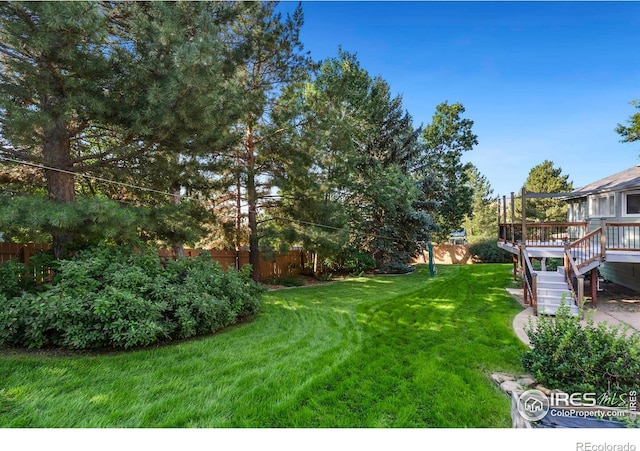 view of yard with a wooden deck