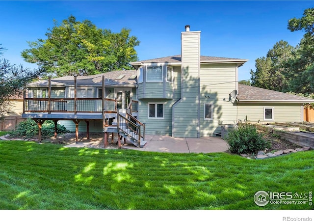 back of house with a wooden deck, a yard, and a patio area