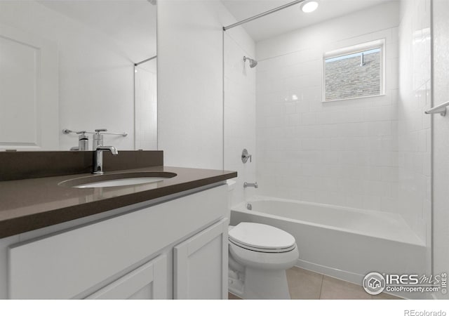 full bathroom with tiled shower / bath, vanity, toilet, and tile patterned floors