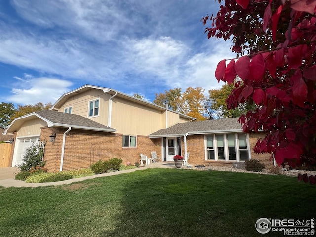 view of front of home featuring a garage and a front yard