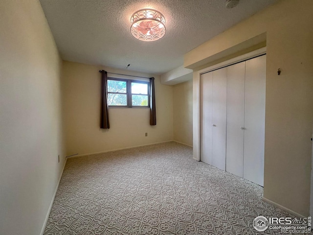 unfurnished bedroom with a textured ceiling and a closet