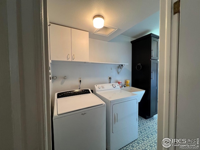 laundry area with cabinets, washer and clothes dryer, and sink