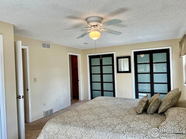 carpeted bedroom with a closet, a textured ceiling, and ceiling fan