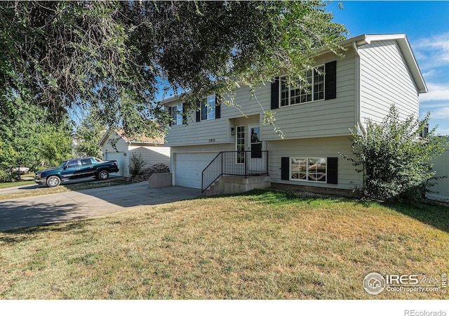 split foyer home featuring a front yard and a garage