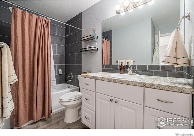 full bathroom with decorative backsplash, hardwood / wood-style flooring, toilet, shower / tub combo with curtain, and vanity