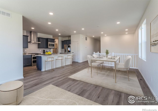 dining area with wood-type flooring and sink