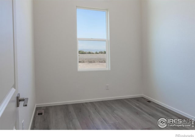 unfurnished room featuring hardwood / wood-style floors