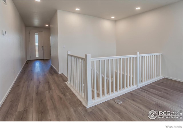 corridor featuring dark hardwood / wood-style flooring