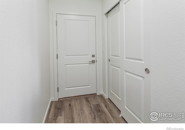 hallway with light hardwood / wood-style floors