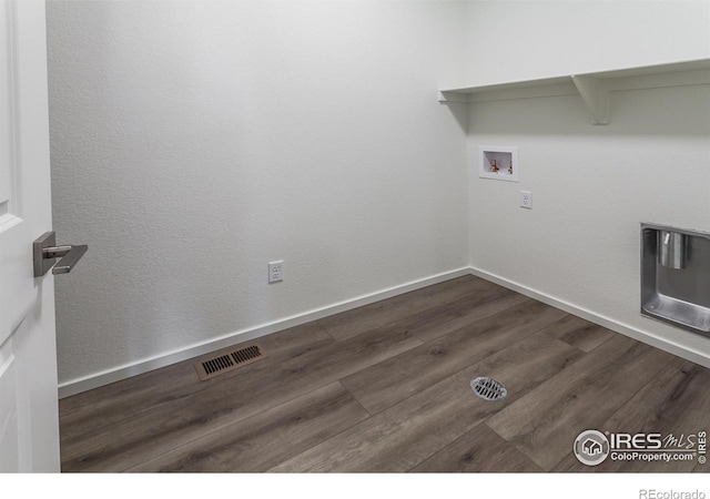 clothes washing area featuring dark wood-type flooring and washer hookup