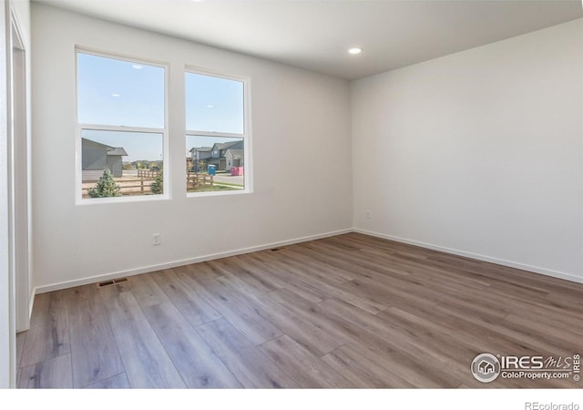 spare room with light hardwood / wood-style flooring