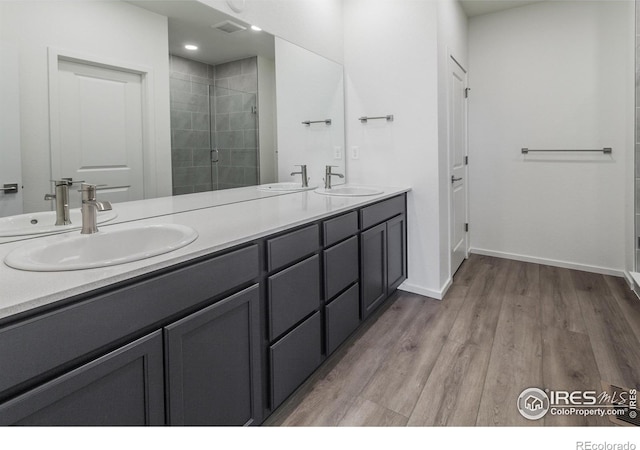 bathroom featuring vanity, an enclosed shower, and hardwood / wood-style floors