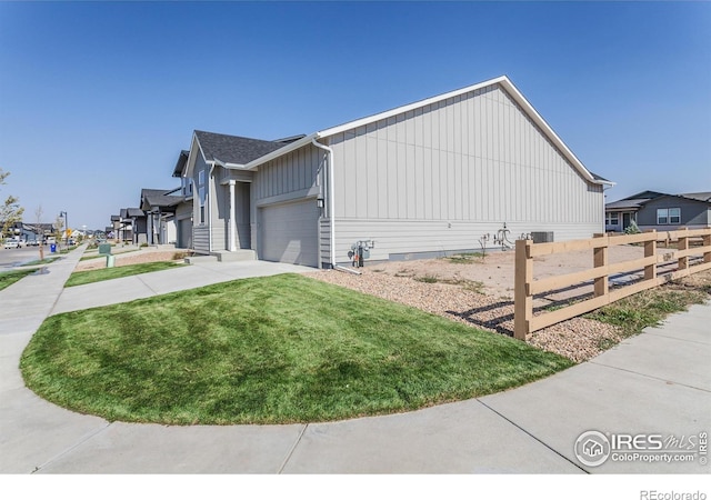 view of property exterior featuring a garage and a yard