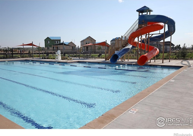 view of pool with a water slide