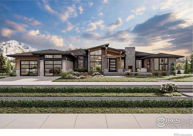 35051 Hillhouse Ln, Windsor, CO 80550 - view of front facade with stone siding, a garage, and concrete driveway