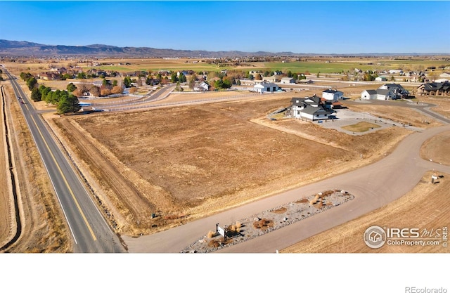 birds eye view of property featuring a mountain view