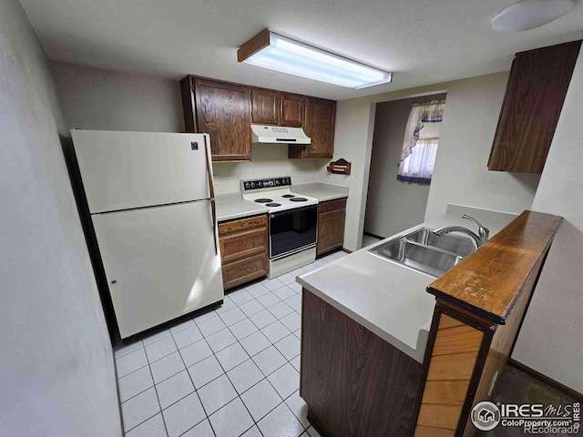 kitchen featuring sink, light tile patterned flooring, dark brown cabinets, and white appliances