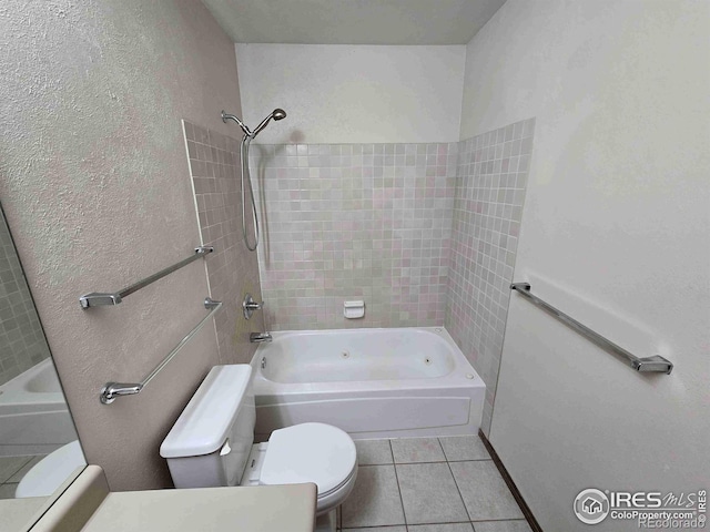 bathroom featuring tile patterned floors, tiled shower / bath combo, and toilet