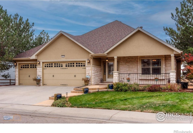 craftsman-style house with a garage, covered porch, and a front lawn