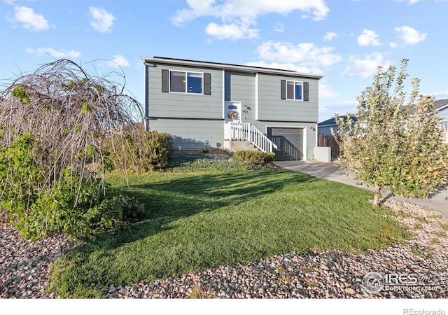 raised ranch featuring a front yard and a garage