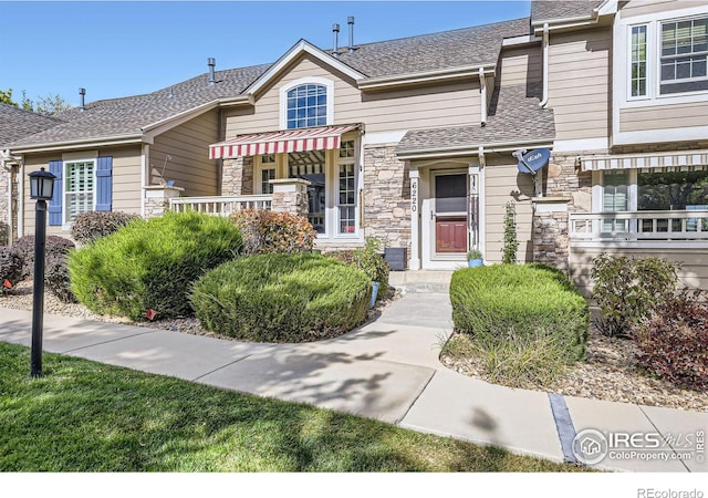 6220 Salvia St, Arvada, CO 80403 - view of property with stone siding and roof with shingles