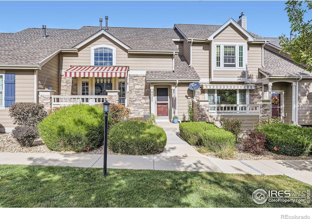 6220 Salvia St, Arvada, CO 80403 - view of front facade with stone siding and a shingled roof