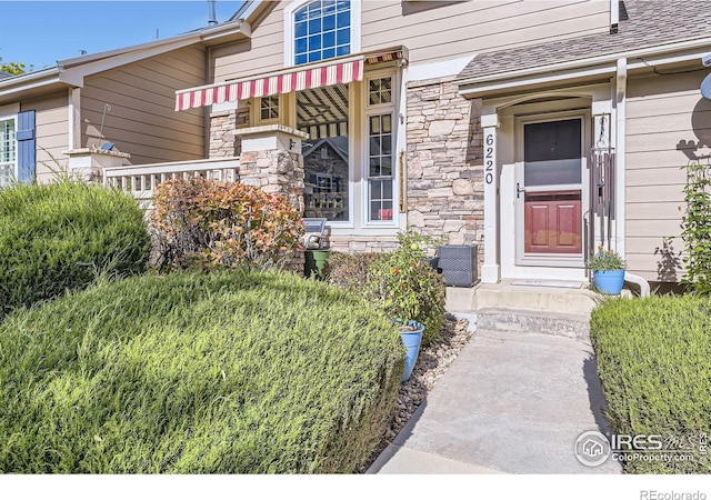 6220 Salvia St, Arvada, CO 80403 - doorway to property with stone siding