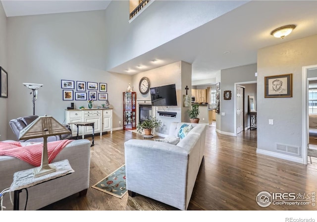 6220 Salvia St, Arvada, CO 80403 - living room with wood finished floors, baseboards, and a towering ceiling