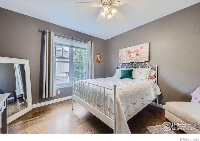 bedroom with dark wood-type flooring and ceiling fan