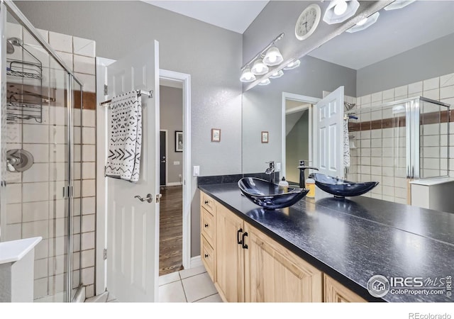 bathroom with vanity, wood-type flooring, and an enclosed shower