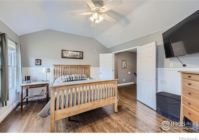 bedroom featuring dark hardwood / wood-style flooring, vaulted ceiling, and ceiling fan