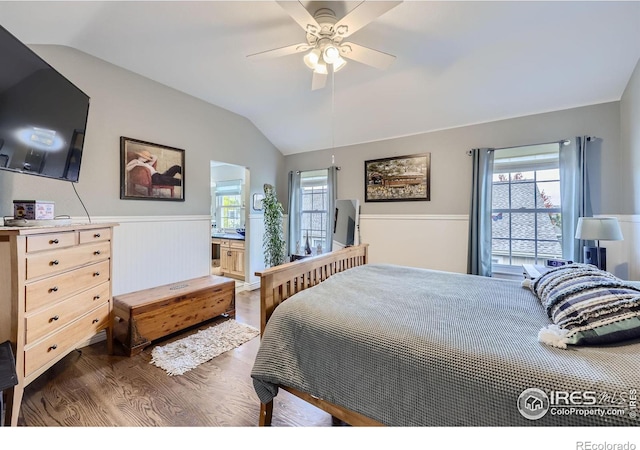 bedroom with ceiling fan, vaulted ceiling, ensuite bathroom, and dark hardwood / wood-style flooring