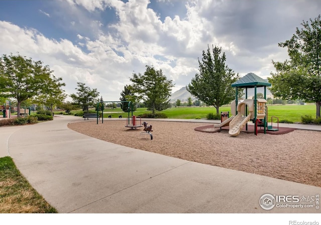 communal playground featuring a lawn