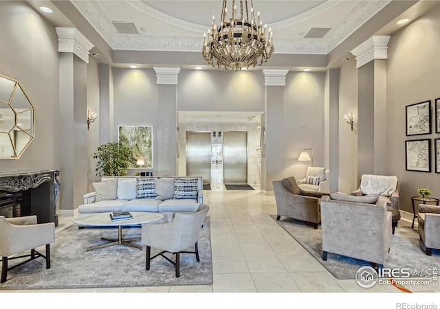 interior space featuring a towering ceiling, ornamental molding, a raised ceiling, and decorative columns