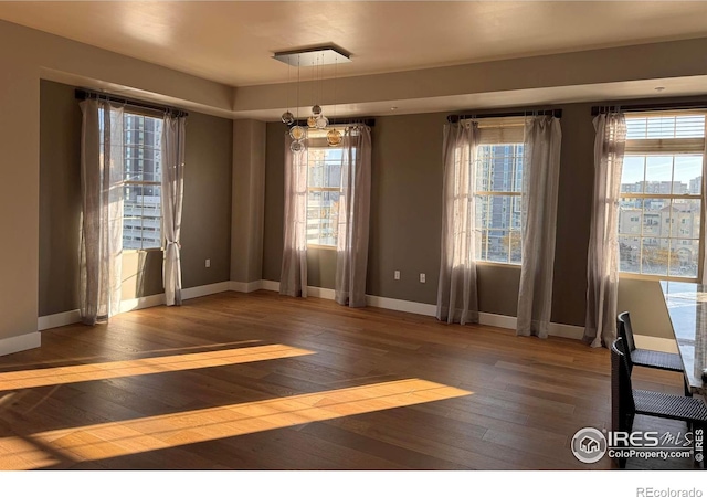 unfurnished dining area with plenty of natural light and dark hardwood / wood-style floors