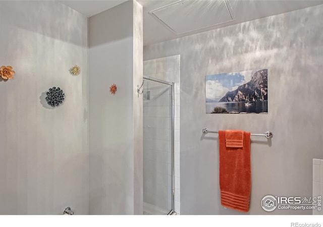 bathroom with a shower with shower door